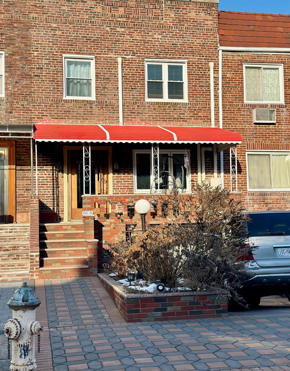 a front view of a house with porch and garden