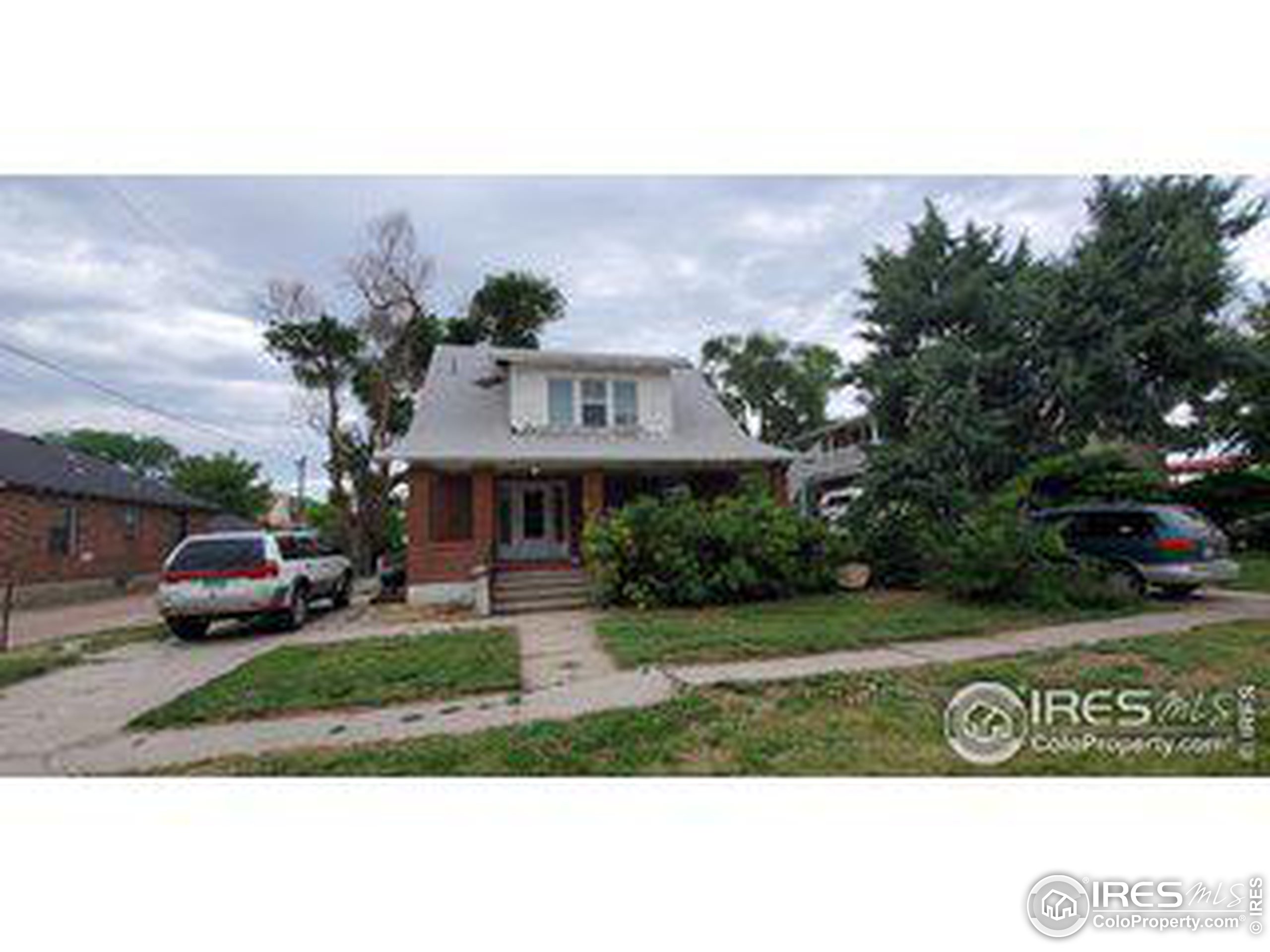 a view of house with garden and car parked