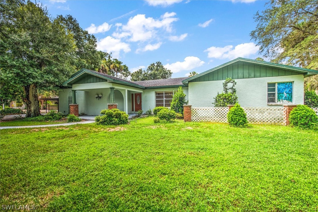 a front view of house with yard and green space