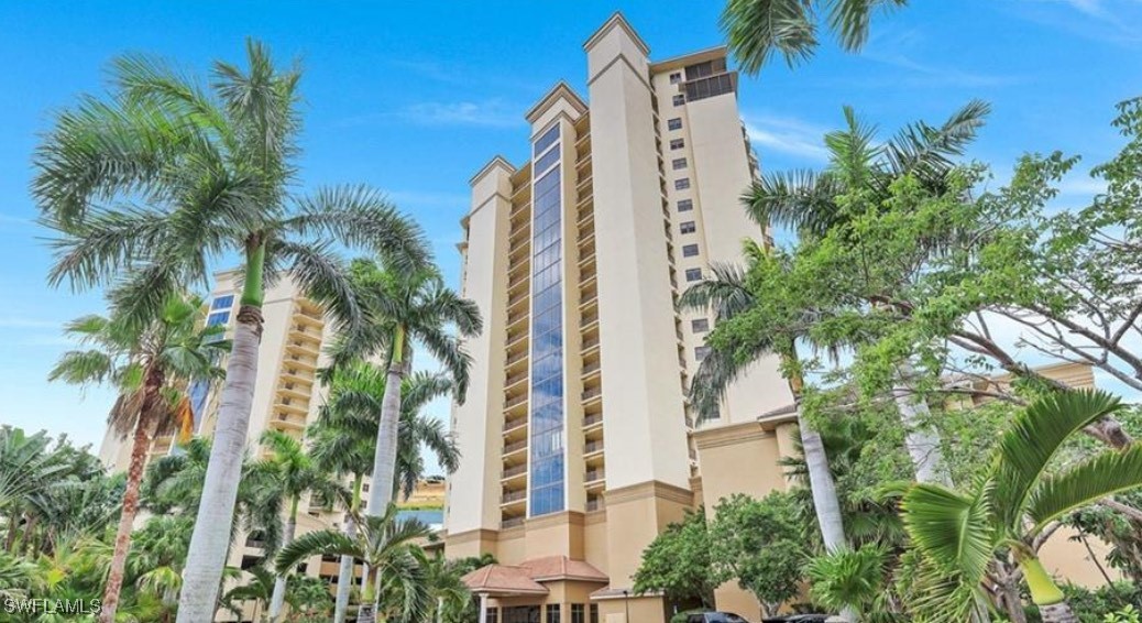 a view of a tall building with a tree in front