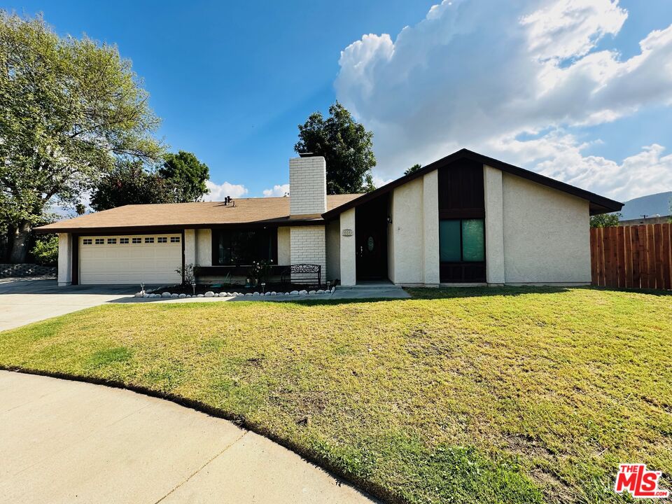 a front view of a house with a yard and a garage