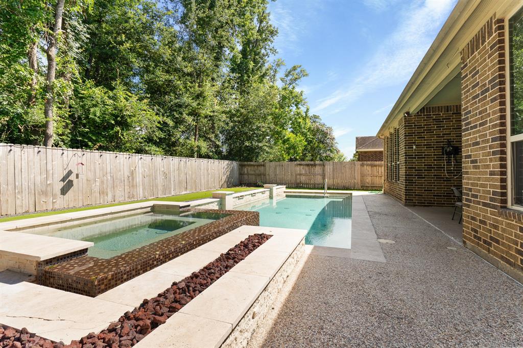 a view of backyard with a swimming pool