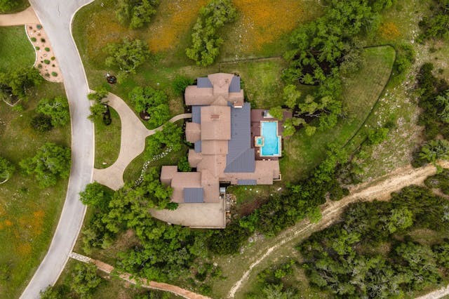 an aerial view of a house with a yard