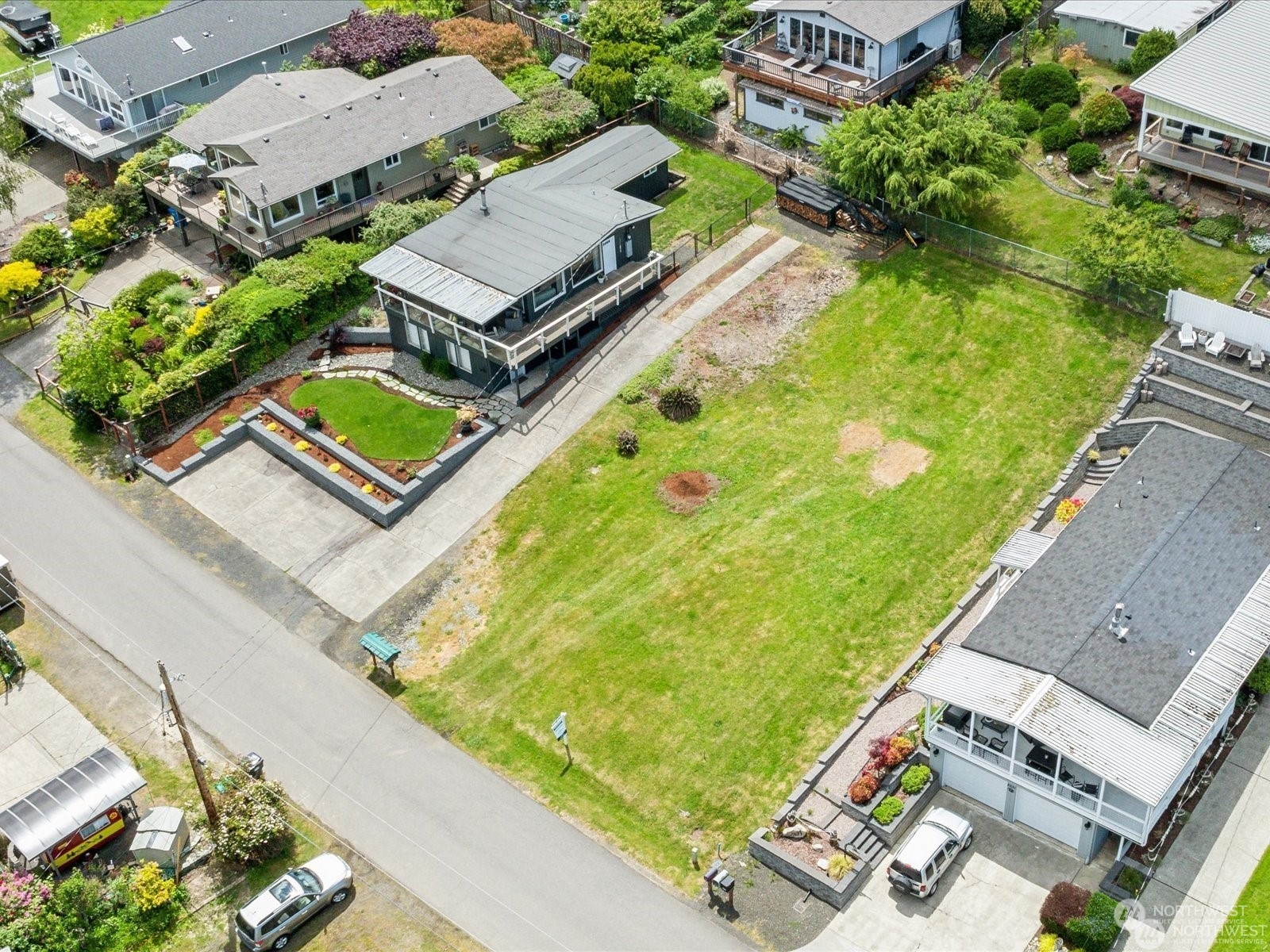 an aerial view of a house with a garden and trees