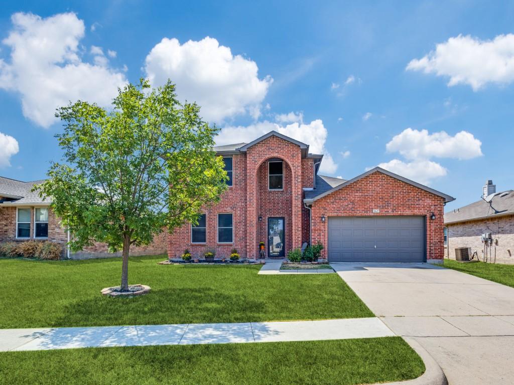 a front view of a house with a yard and garage