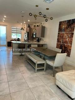 a kitchen with stainless steel appliances kitchen island granite countertop a sink and a black cabinets