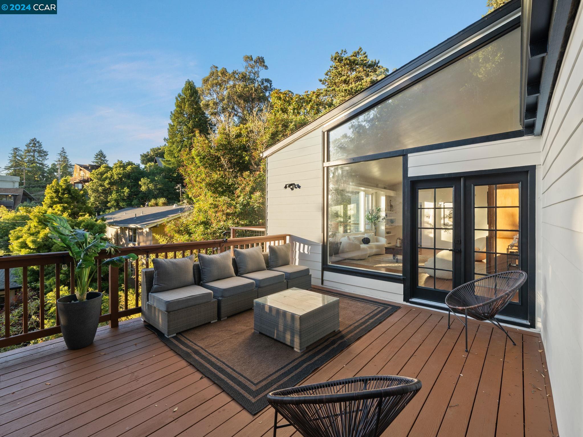 a balcony with furniture and wooden floor