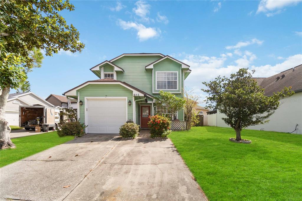 a front view of house with yard and green space