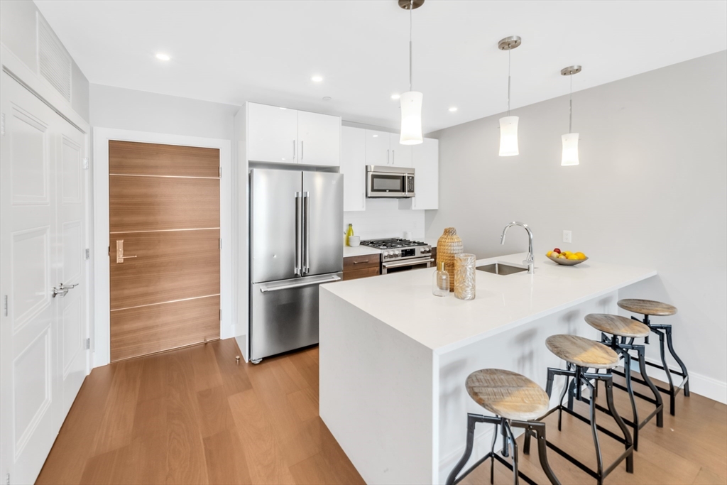 a kitchen with a refrigerator a stove a sink and a refrigerator