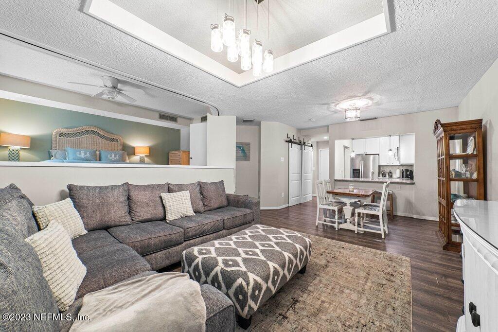 a living room with furniture and a chandelier