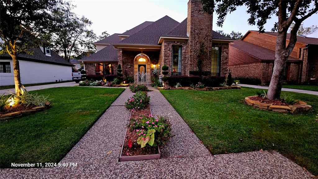 a front view of house with a garden