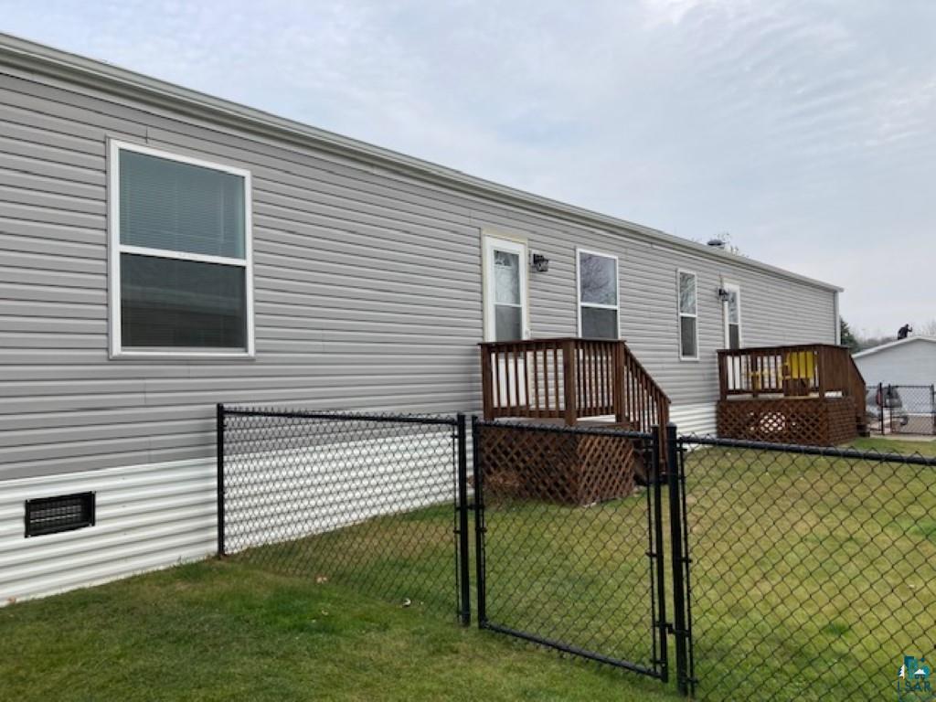 View of front of property with a front yard and a deck