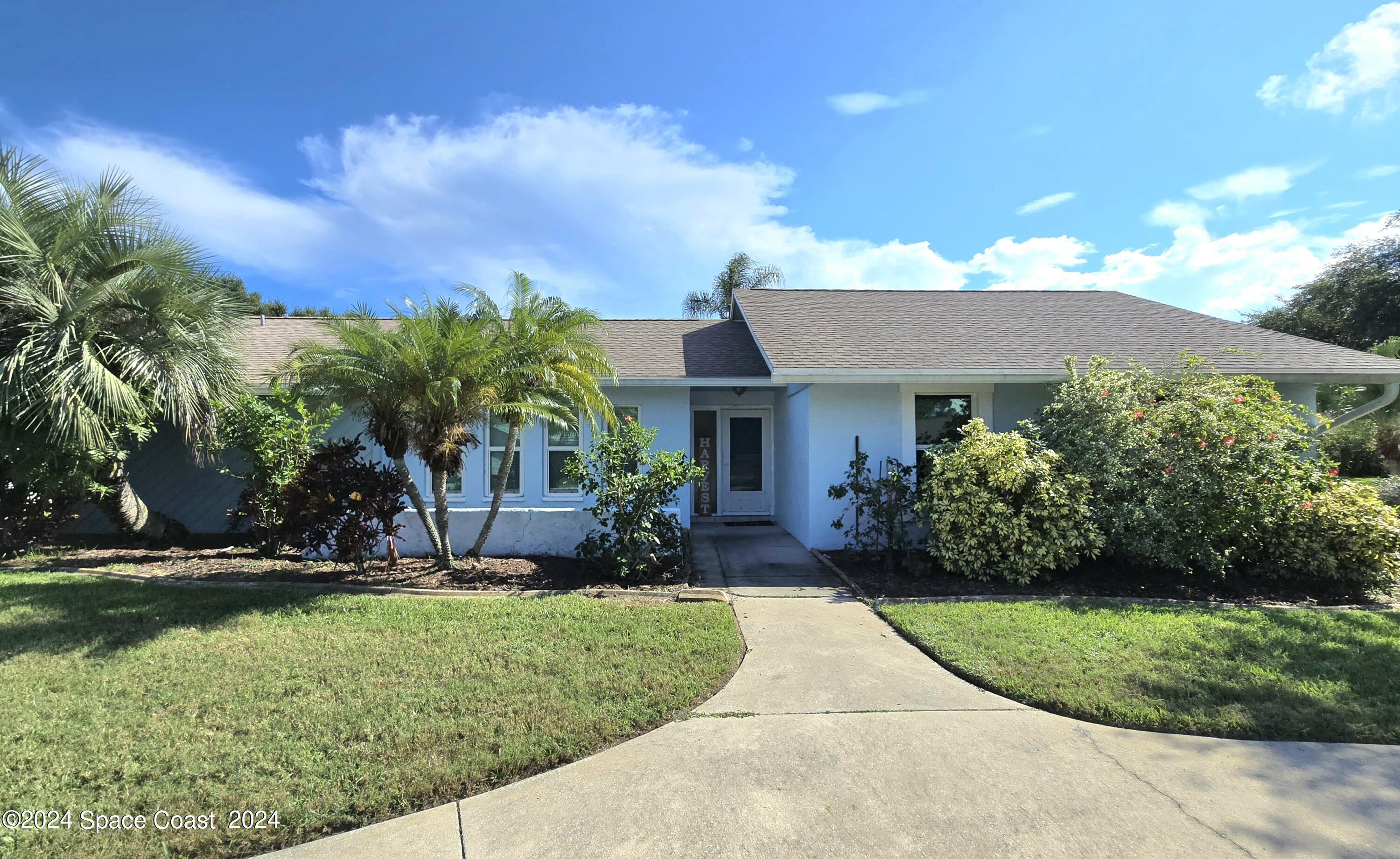 a front view of a house with a yard and porch