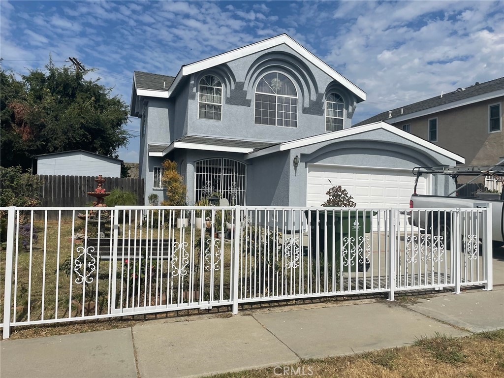 a front view of a house with iron fence