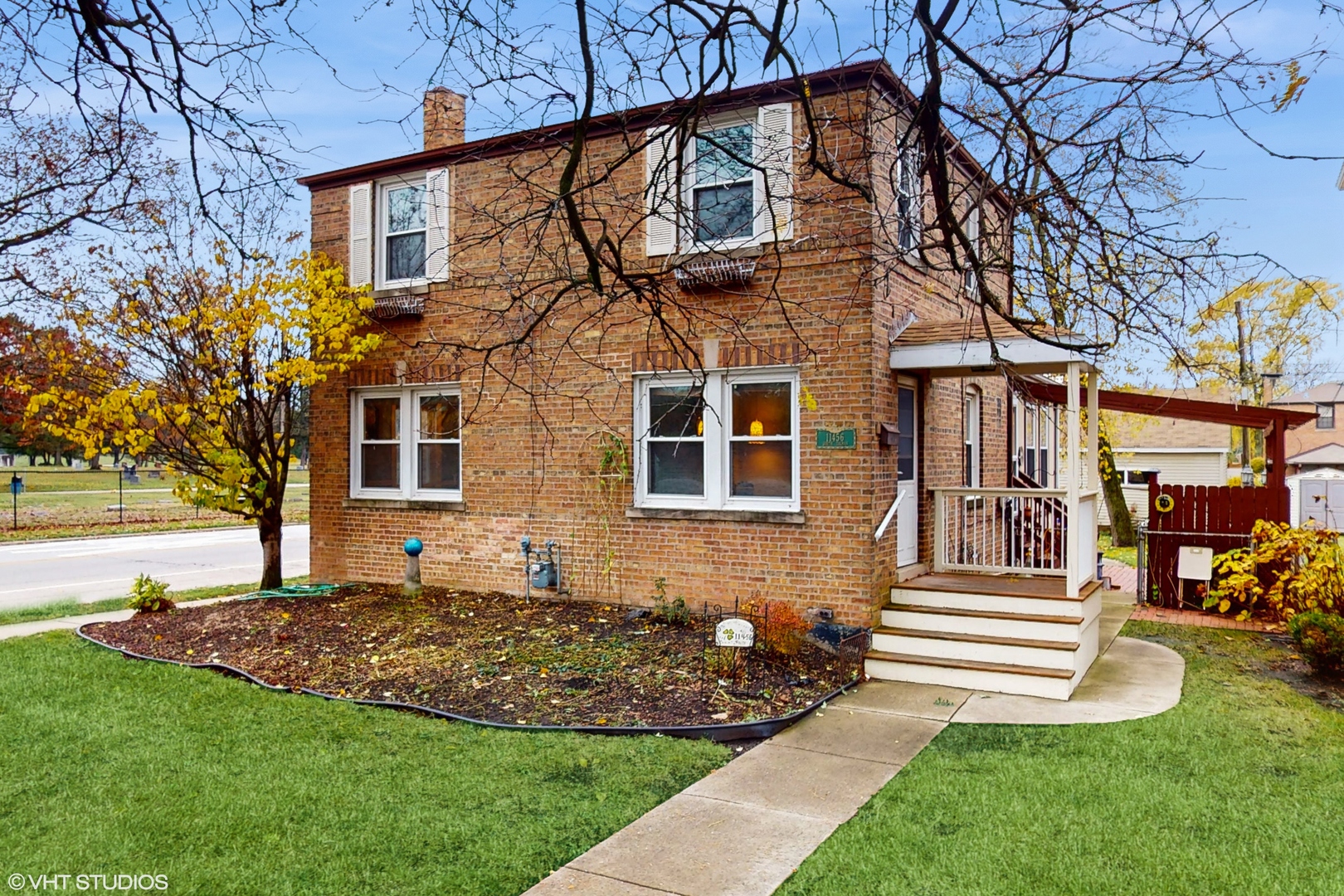 a view of a house with a yard and a garden