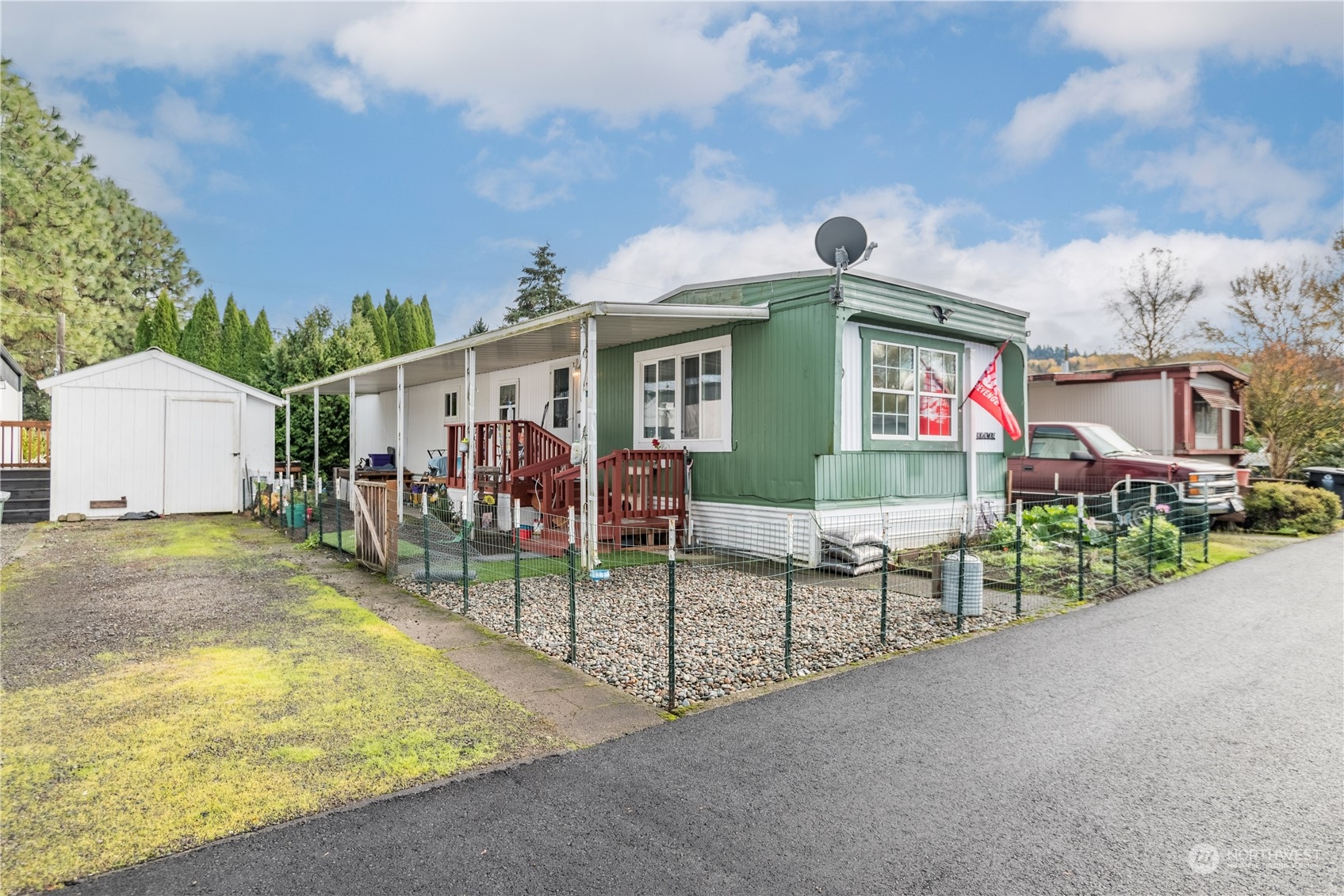 a view of a house with a patio and a yard