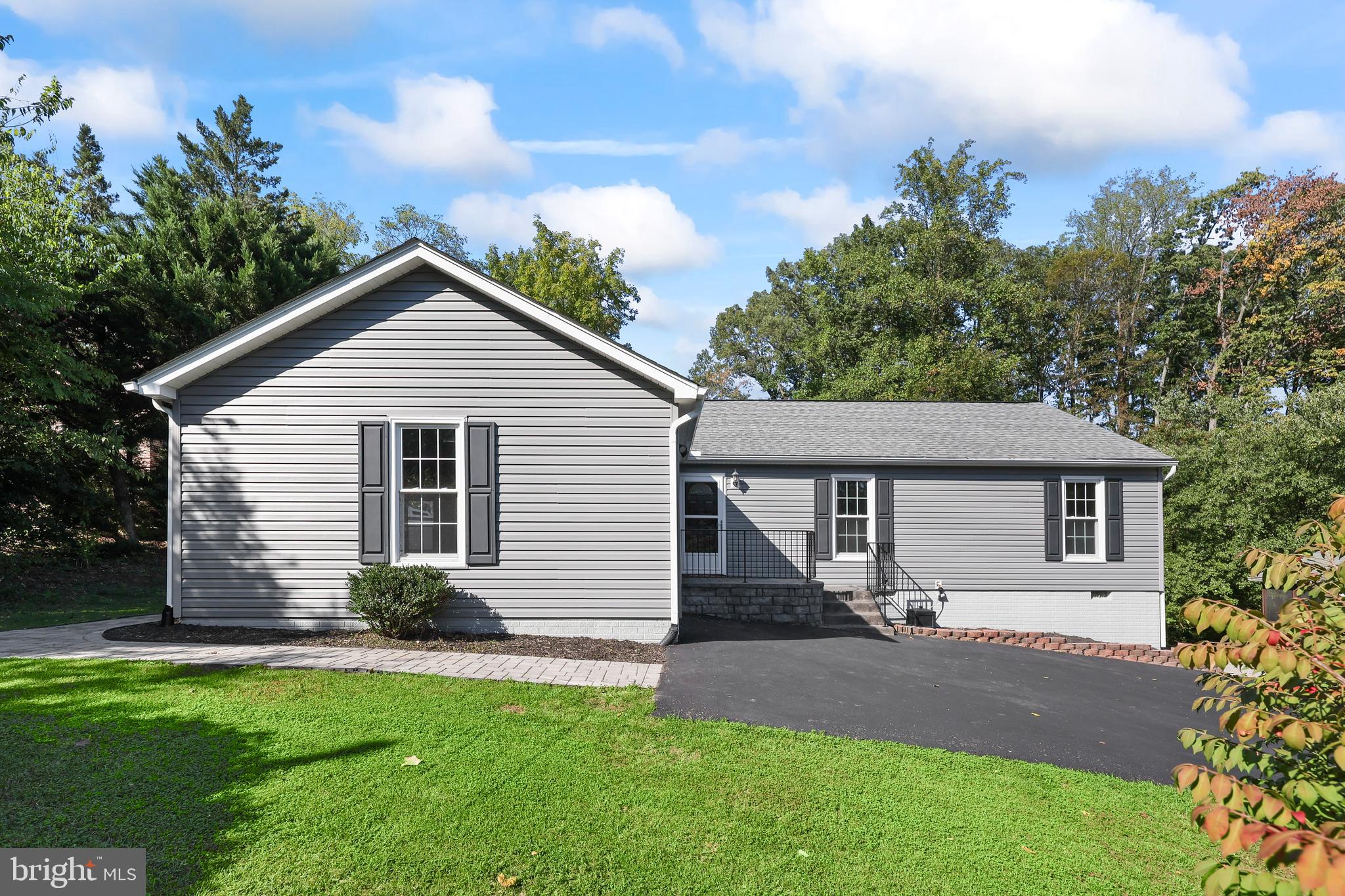 Paved driveway to home with attached garage