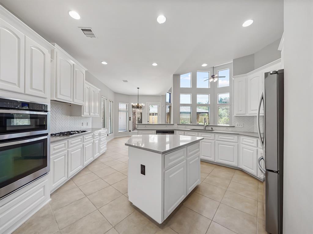 a kitchen with stainless steel appliances granite countertop a stove and cabinets