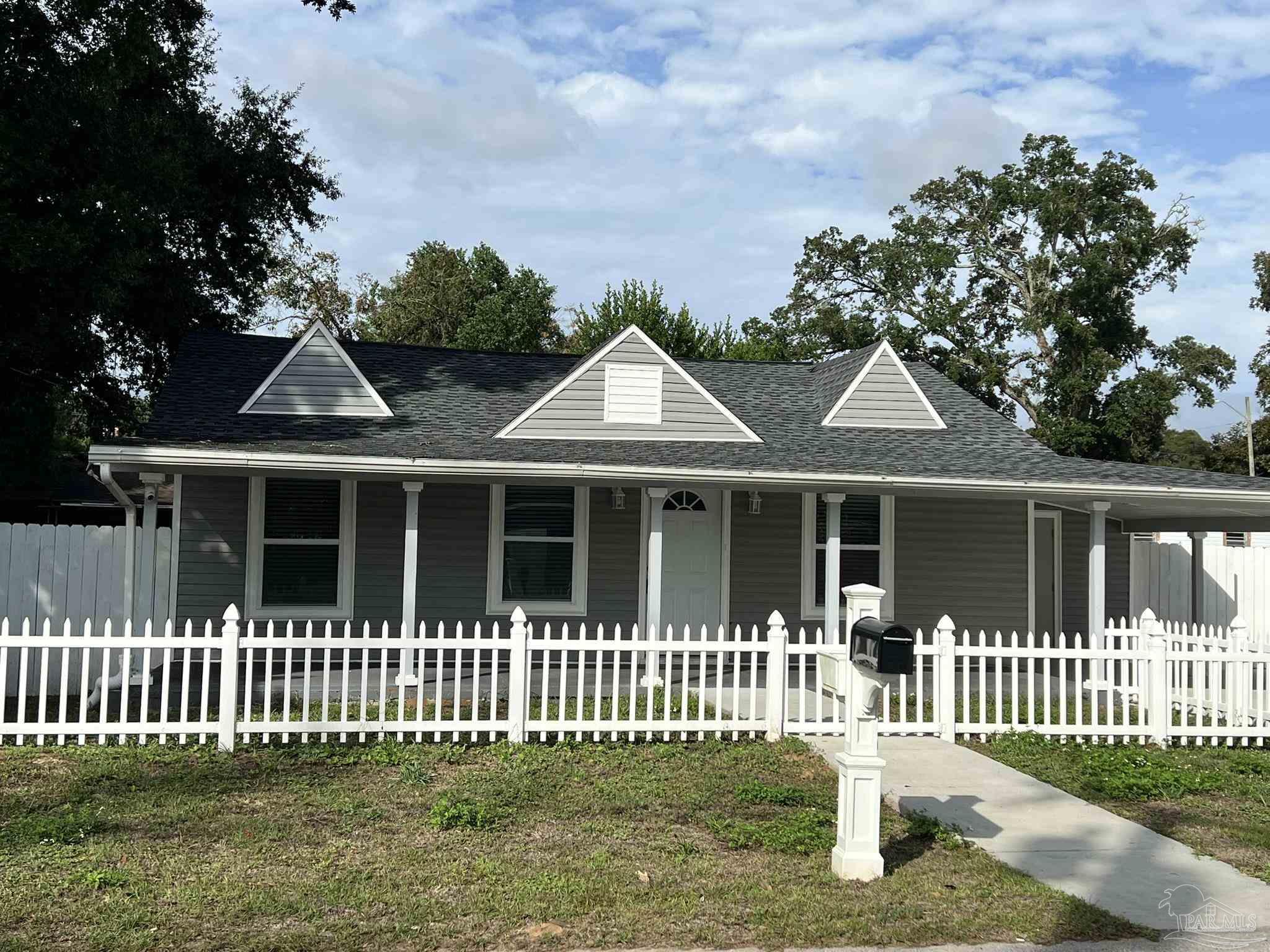 a front view of a house with a garden