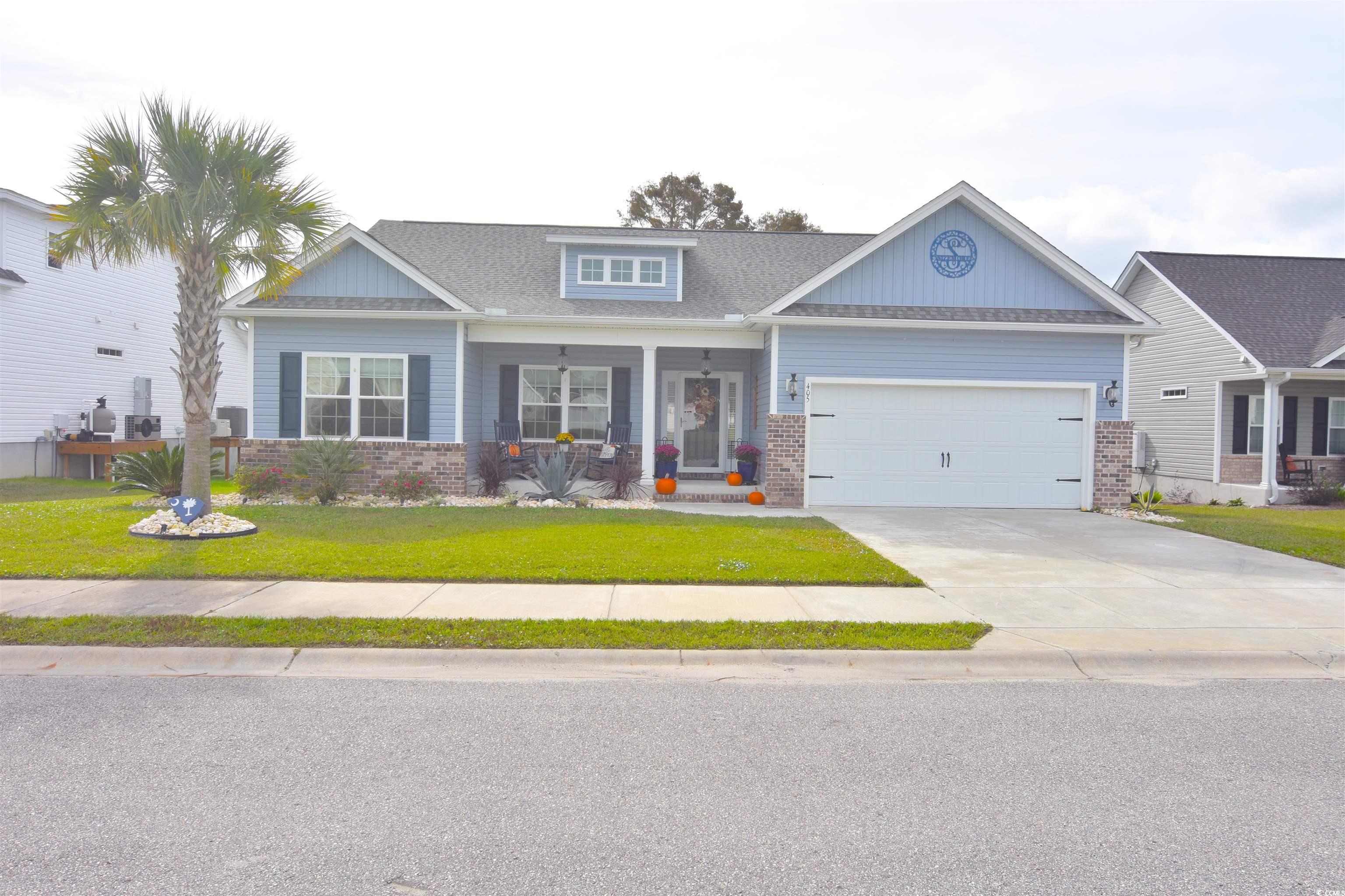 Craftsman house with a garage, a front lawn, and a