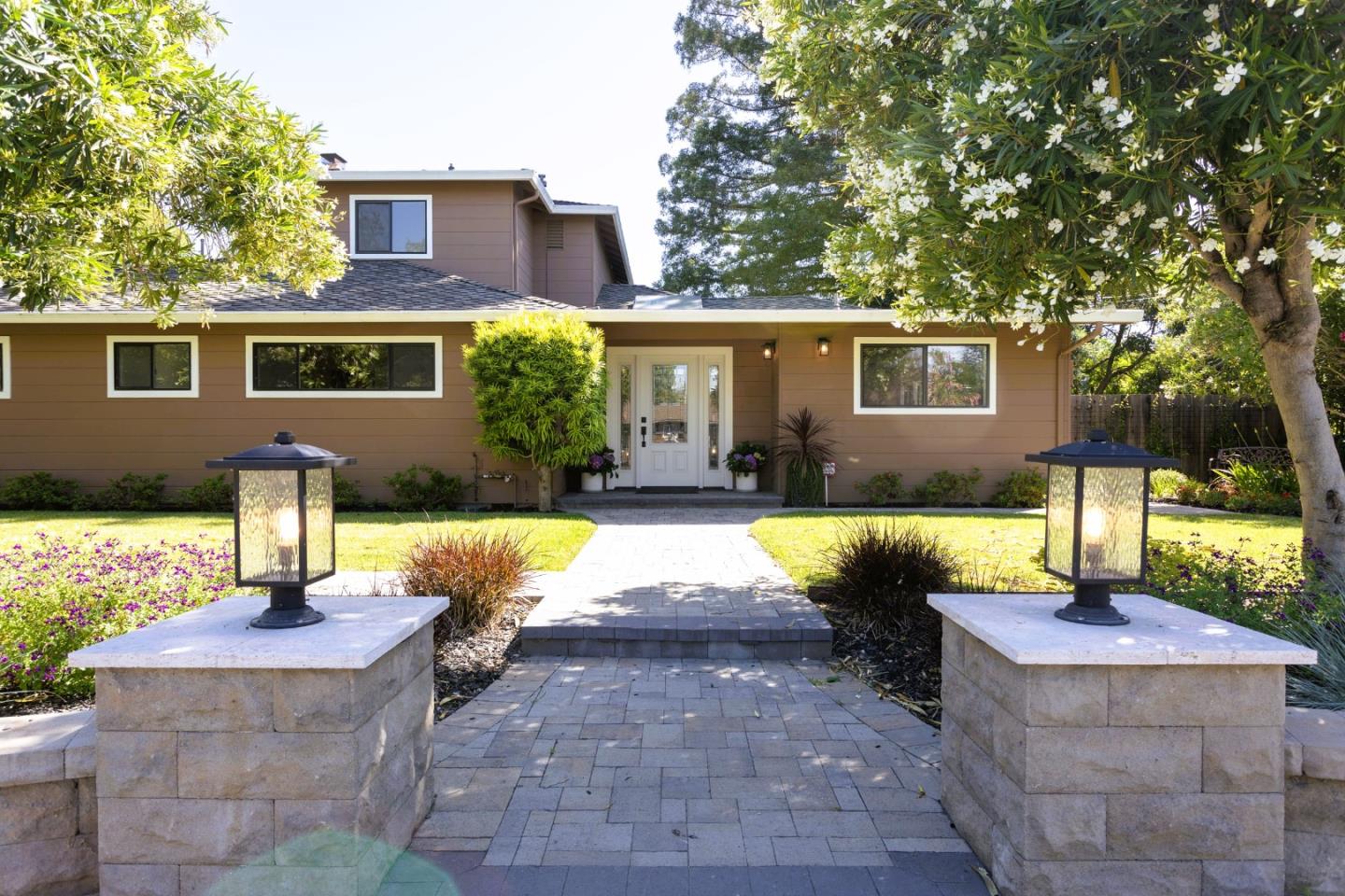 a view of a house with backyard sitting area and swimming pool