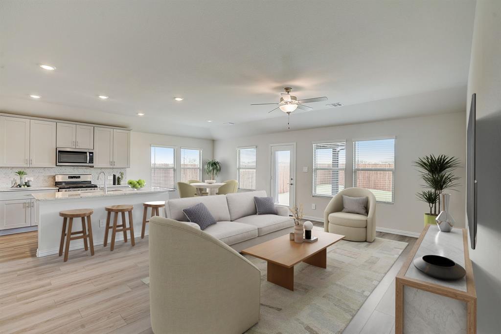 a living room with furniture a dining table and chairs