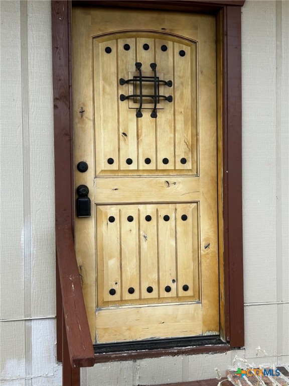 a view of a door with wooden floor