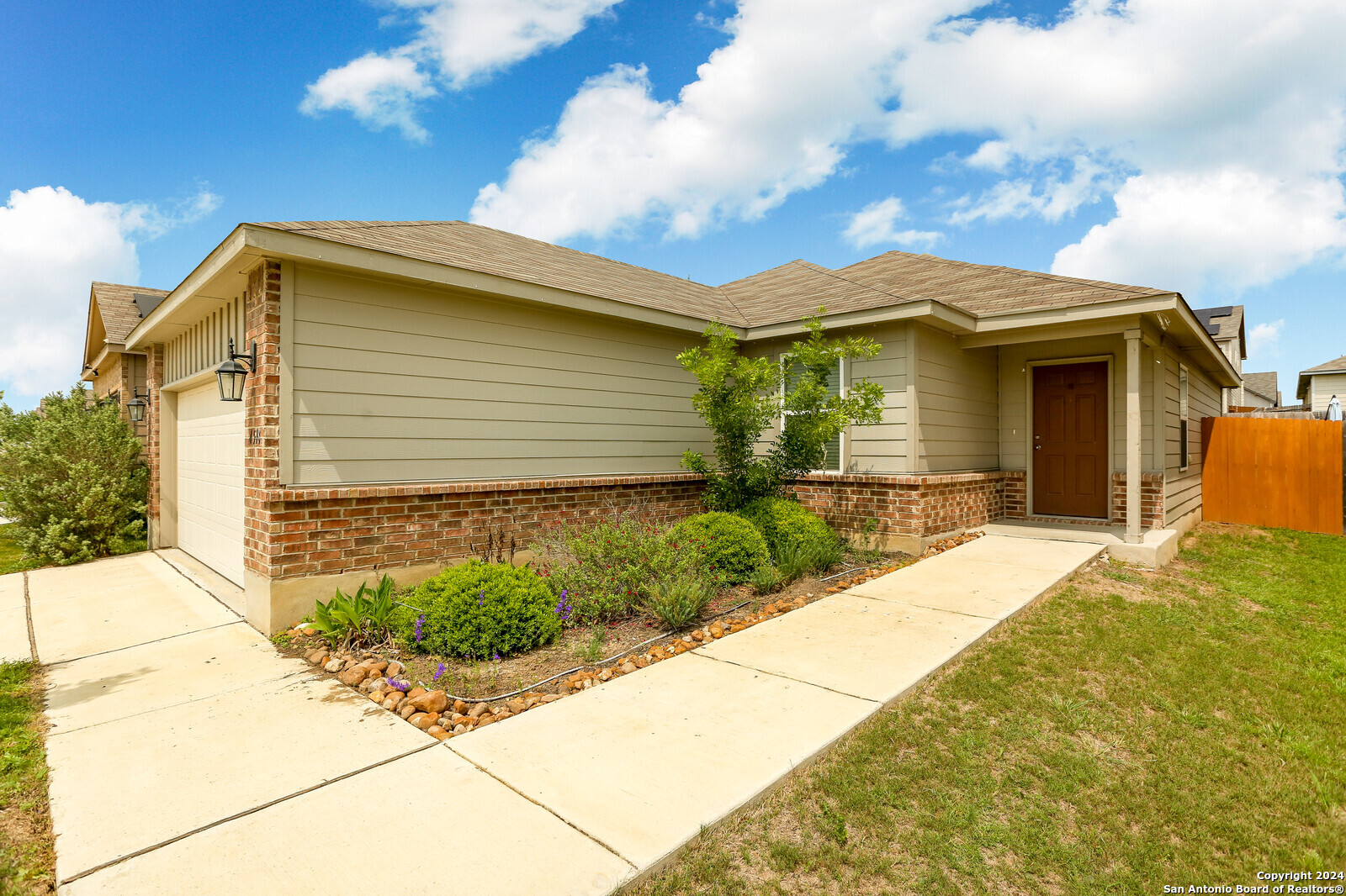 a front view of a house with garden