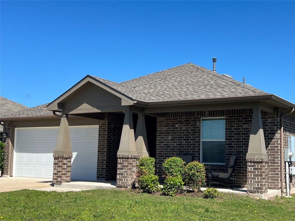 a front view of a house with a garden