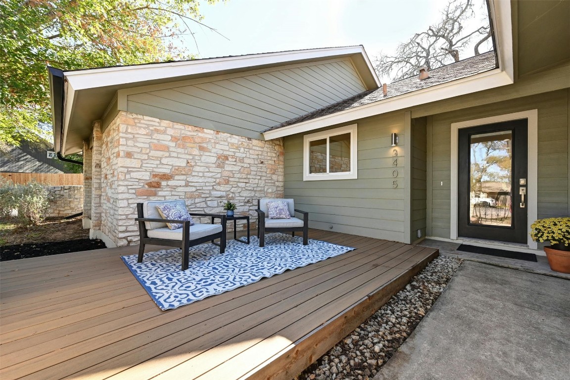 a backyard of a house with barbeque oven table and chairs