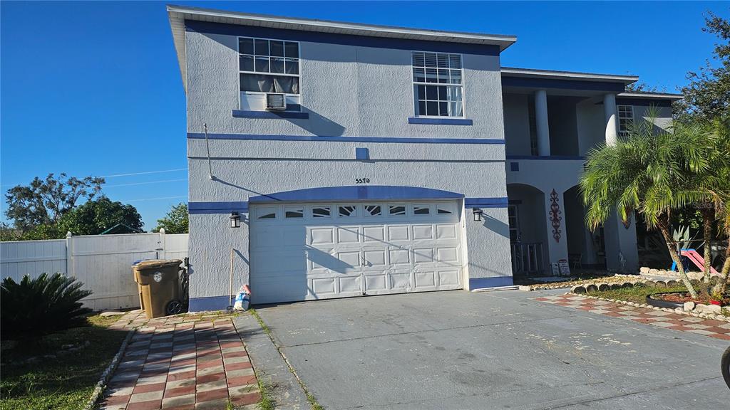 a front view of a house with garage