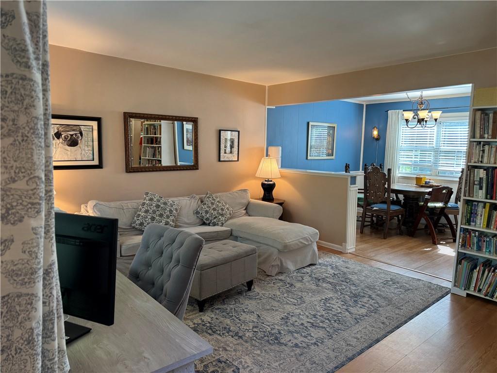 Living room featuring an inviting chandelier and hardwood / wood-style floors