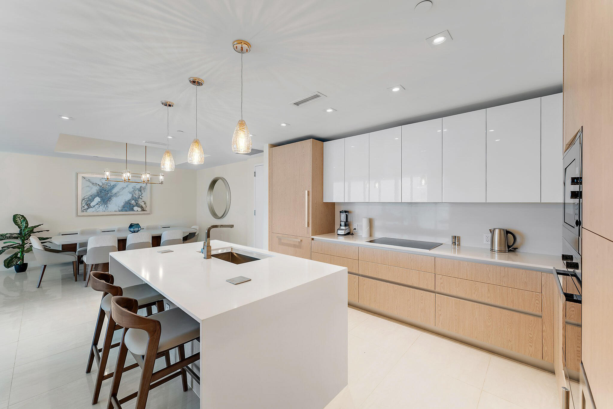 a kitchen with a sink a stove a dining table and chairs