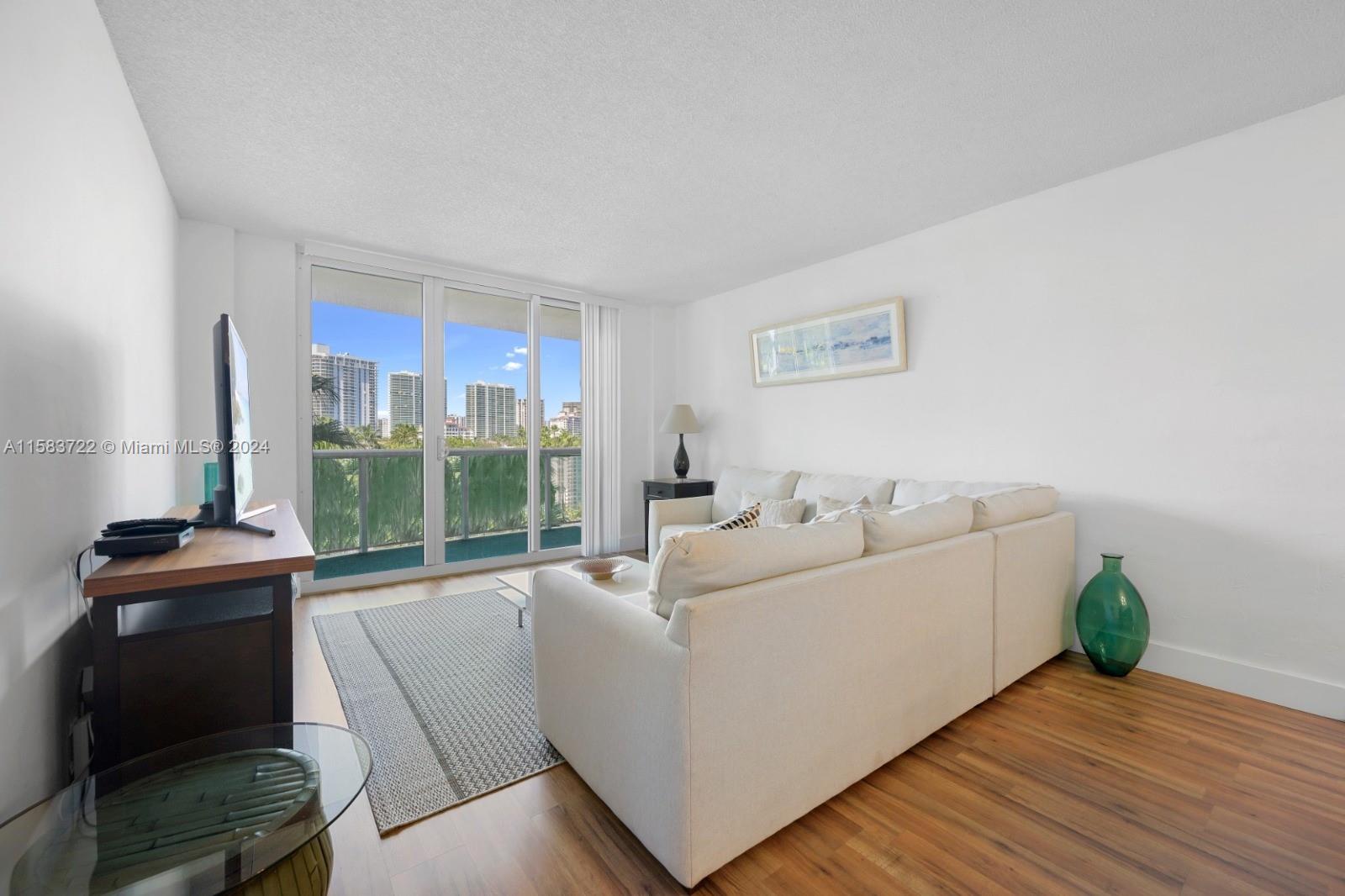 a living room with furniture and a floor to ceiling window