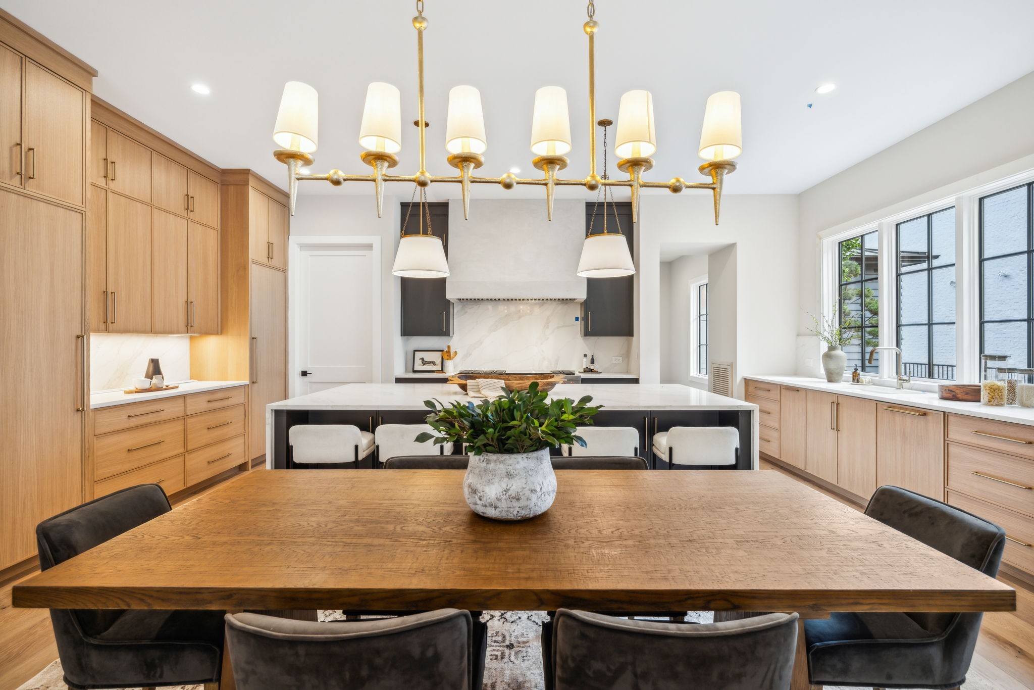 a kitchen with a table chairs and white appliances