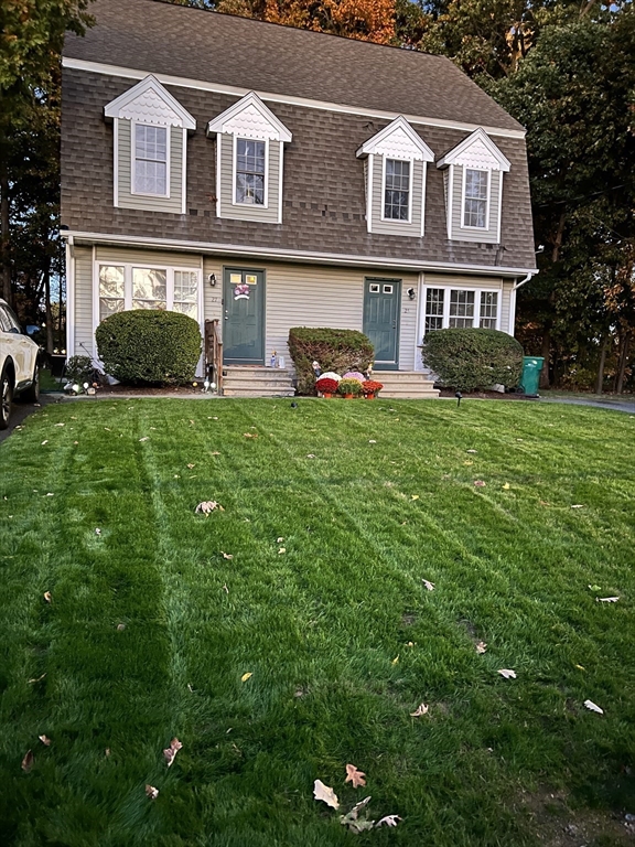 a front view of a house with garden