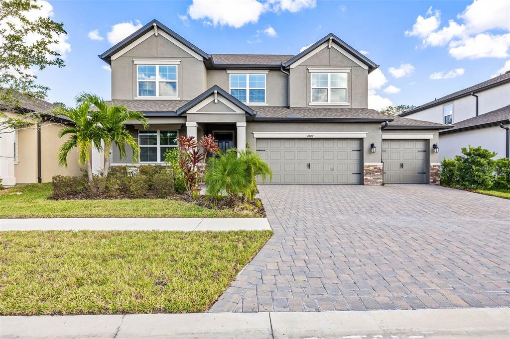 a front view of a house with a yard and garage