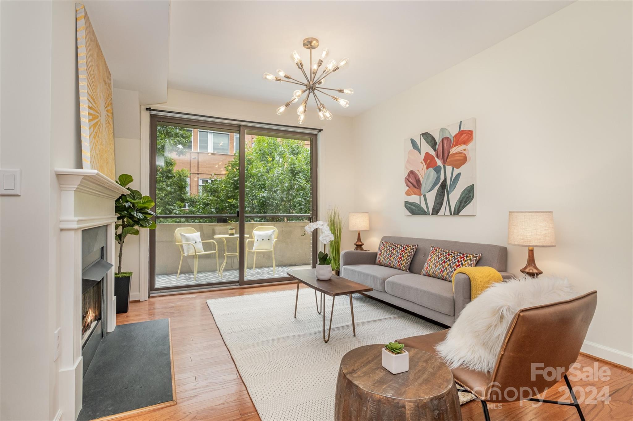 a living room with furniture and a floor to ceiling window