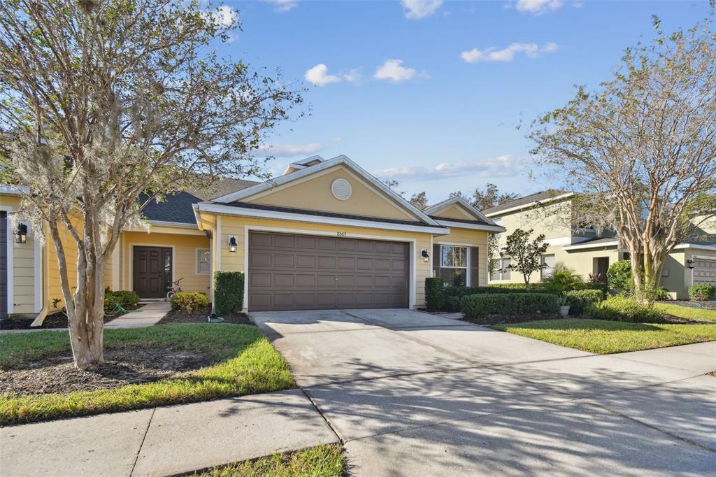 a front view of a house with a yard and garage