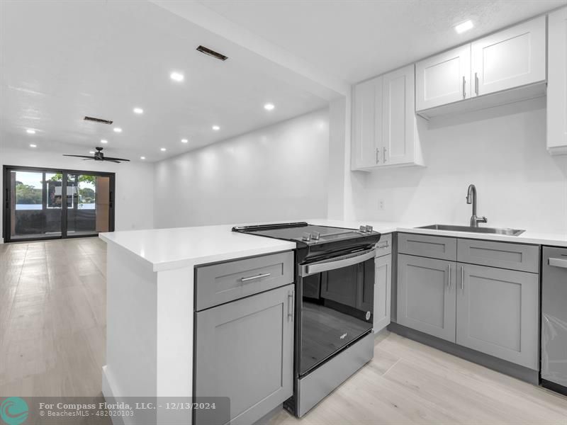 a kitchen with a sink stainless steel appliances and cabinets