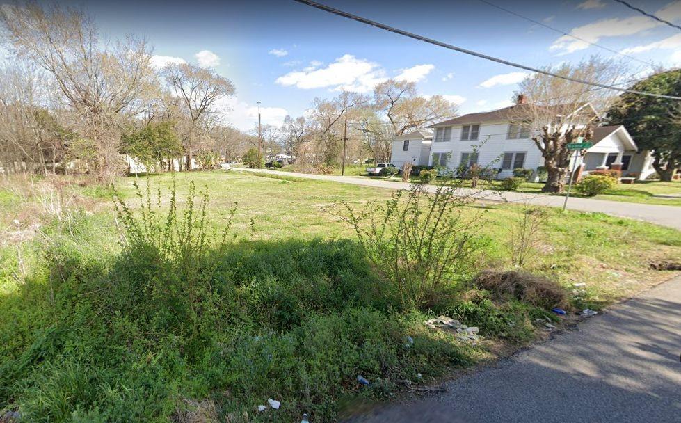 a view of yard with swimming pool and green space