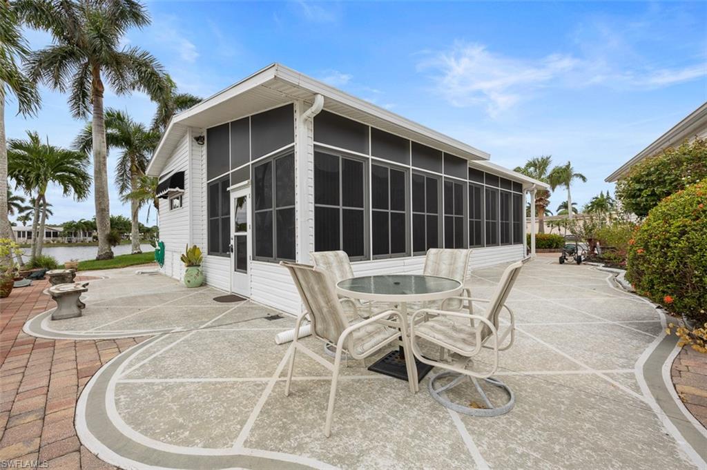 View of patio featuring a sunroom