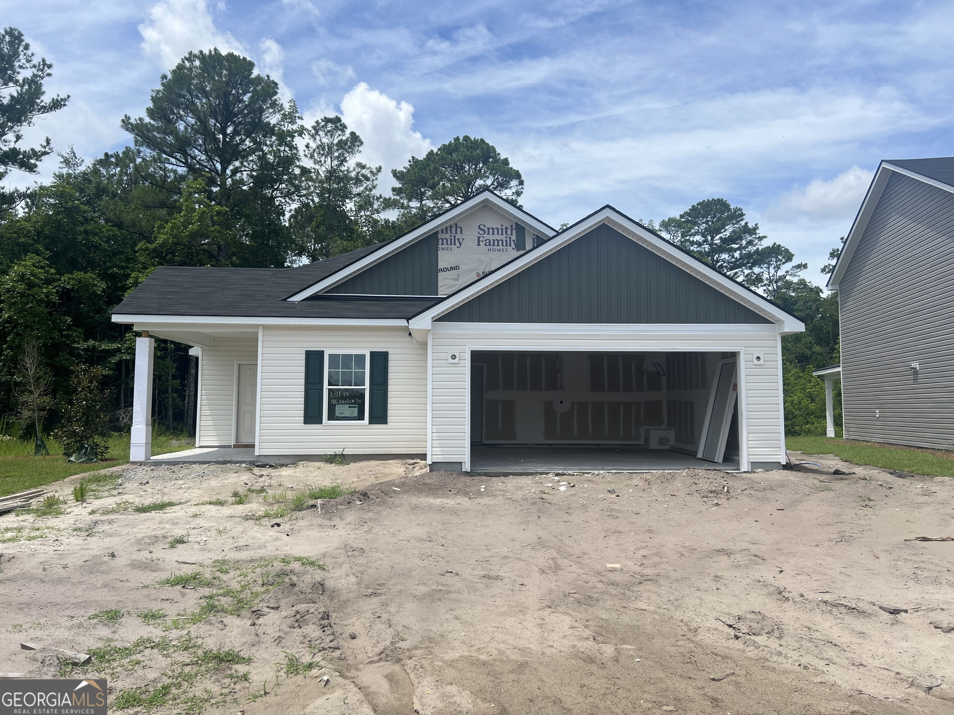 a front view of a house with yard and garage