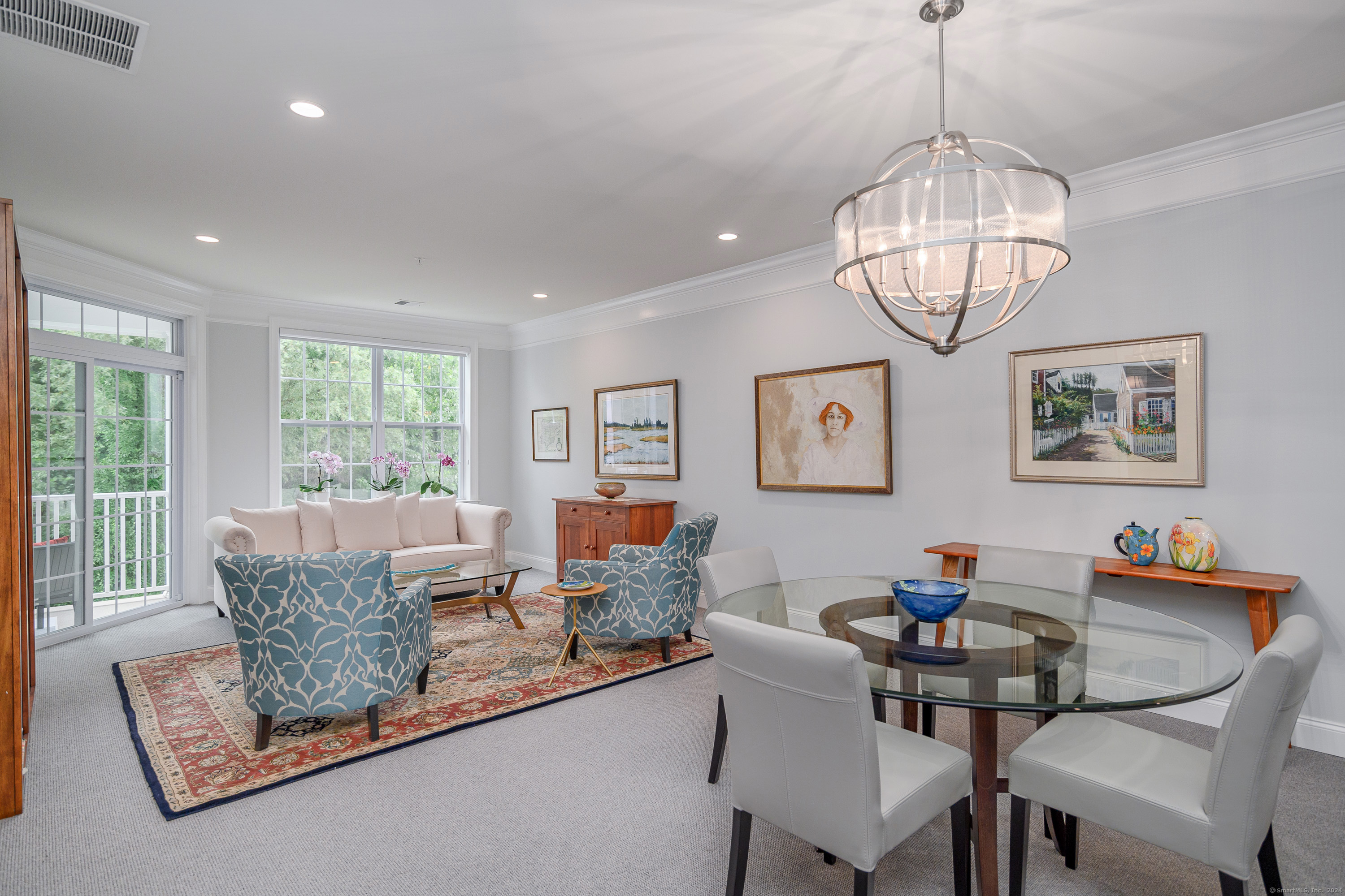 a living room with furniture chandelier and a window