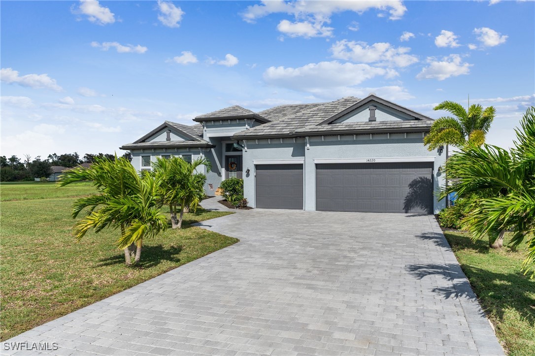 a front view of a house with a yard and garage