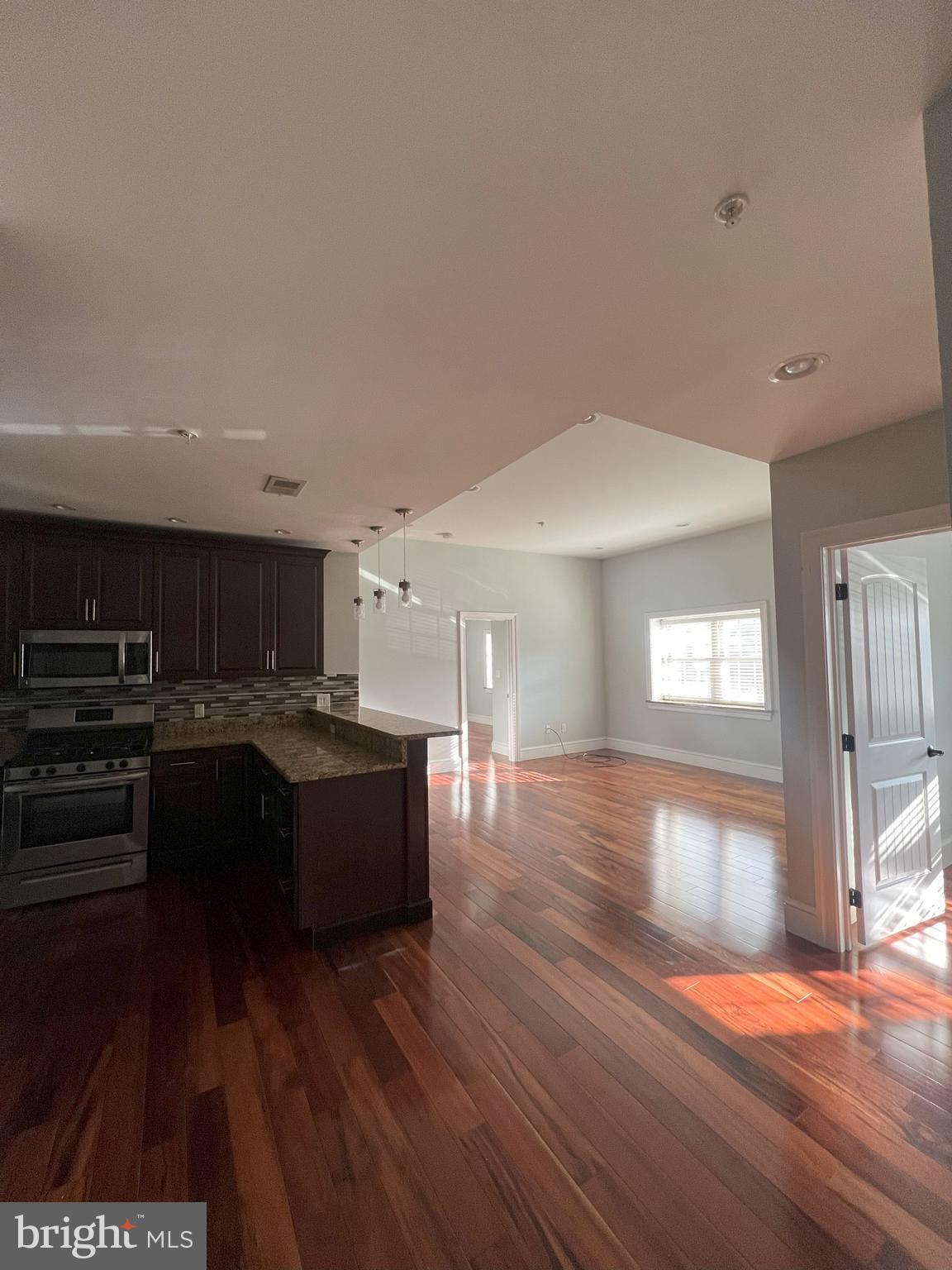 a kitchen with a sink and a stove top oven