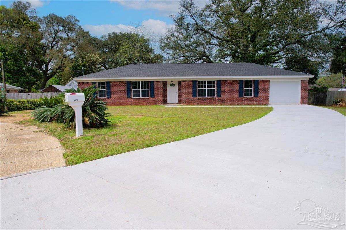 a front view of a house with yard patio and green space