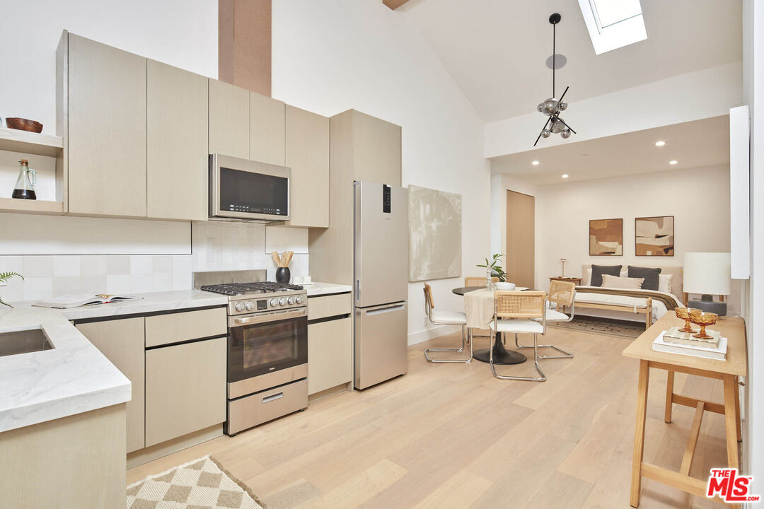 a kitchen with a stove a sink and a refrigerator