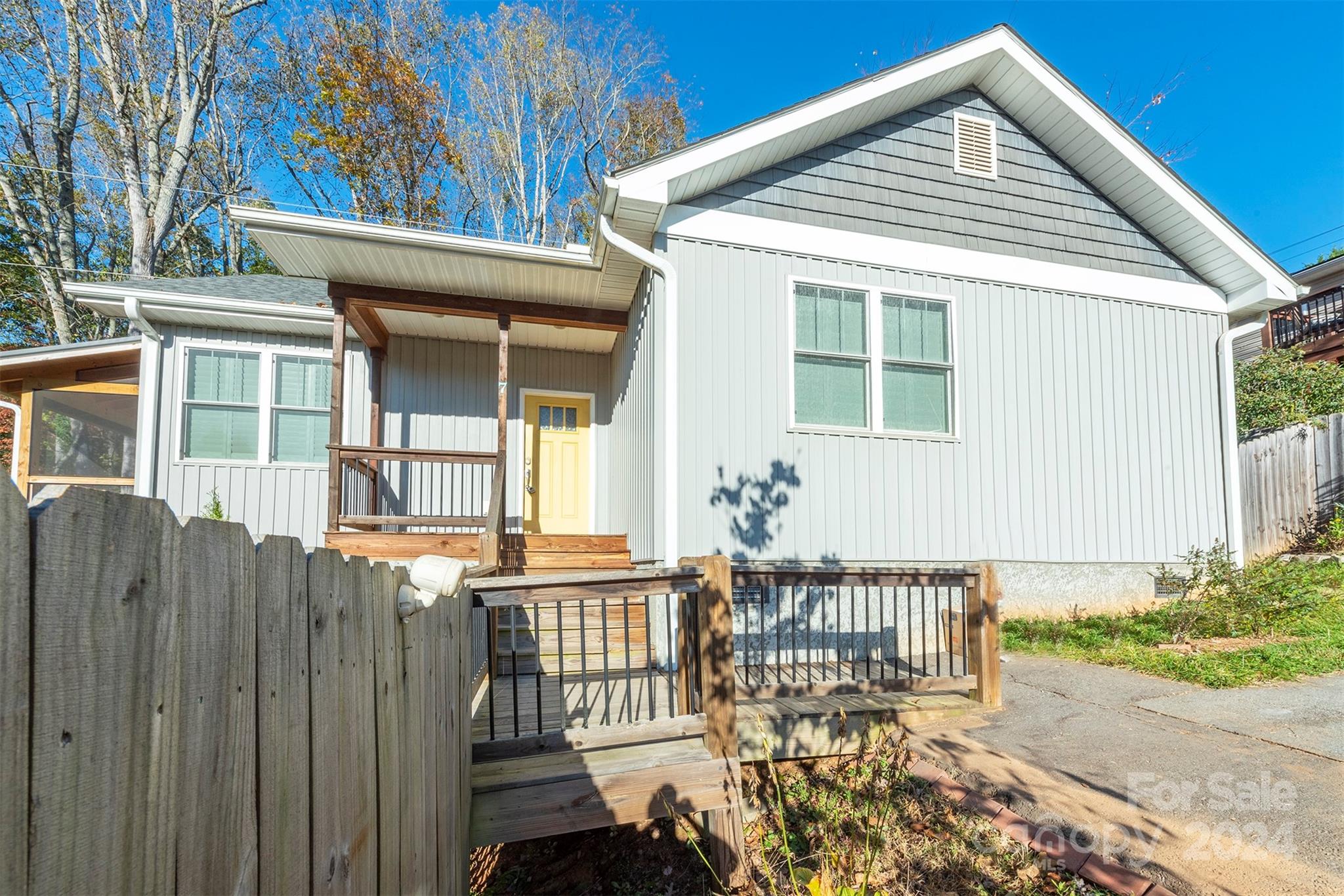 a view of a house with a wooden fence