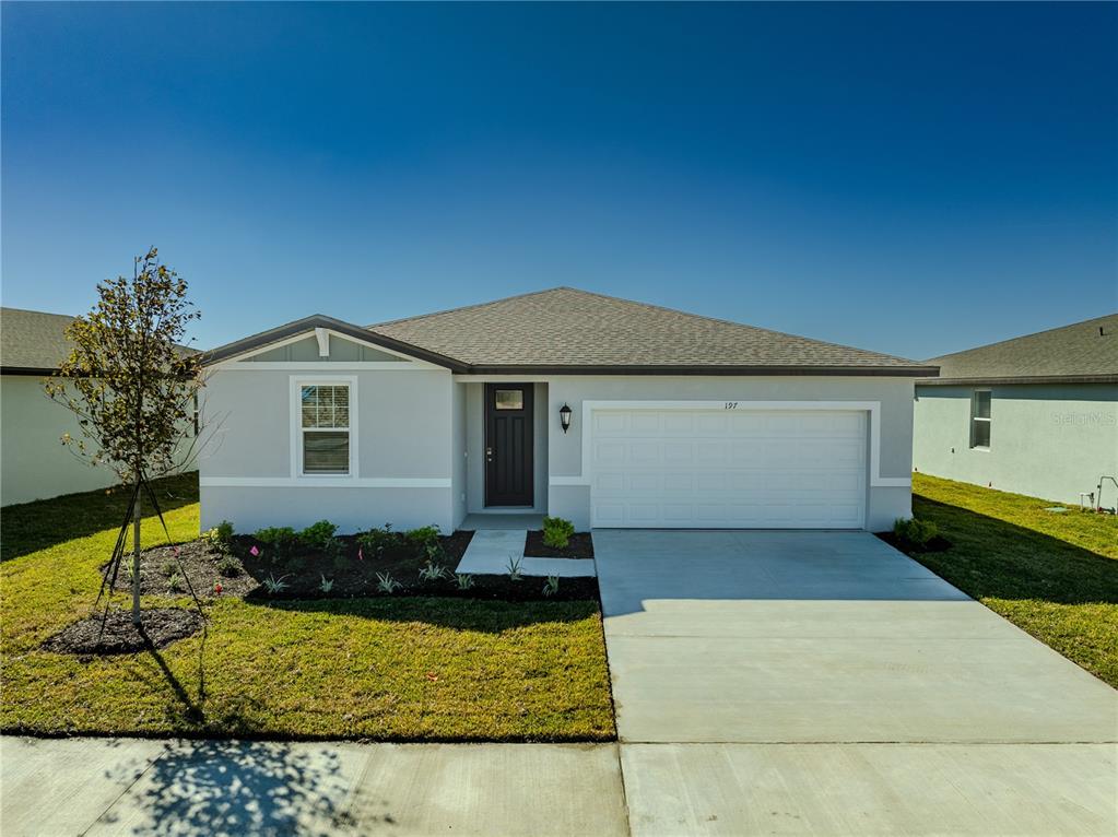 a front view of a house with garden